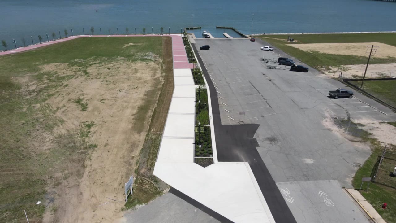 Drone view of a waterfront parking lot and shoreline