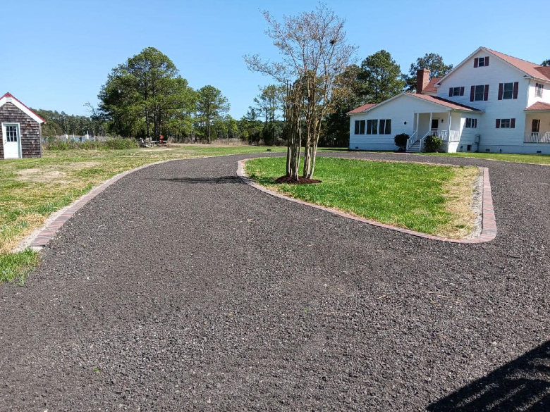 Recycled asphalt millings driveway with brick edging